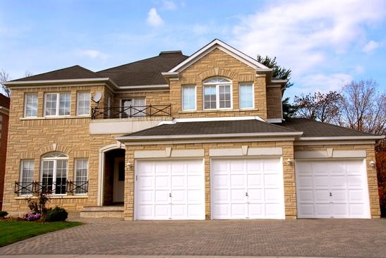 New detached single family luxury home with stone facade and tripple garage